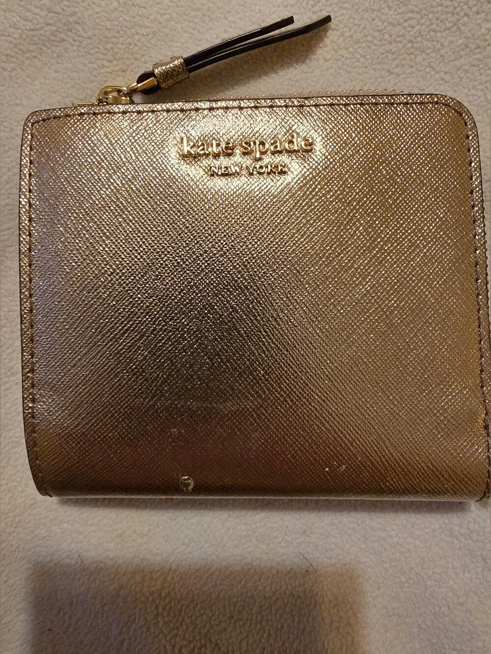 Kate Spade New York Staci small zip-around bifold wallet featuring a glittery ro